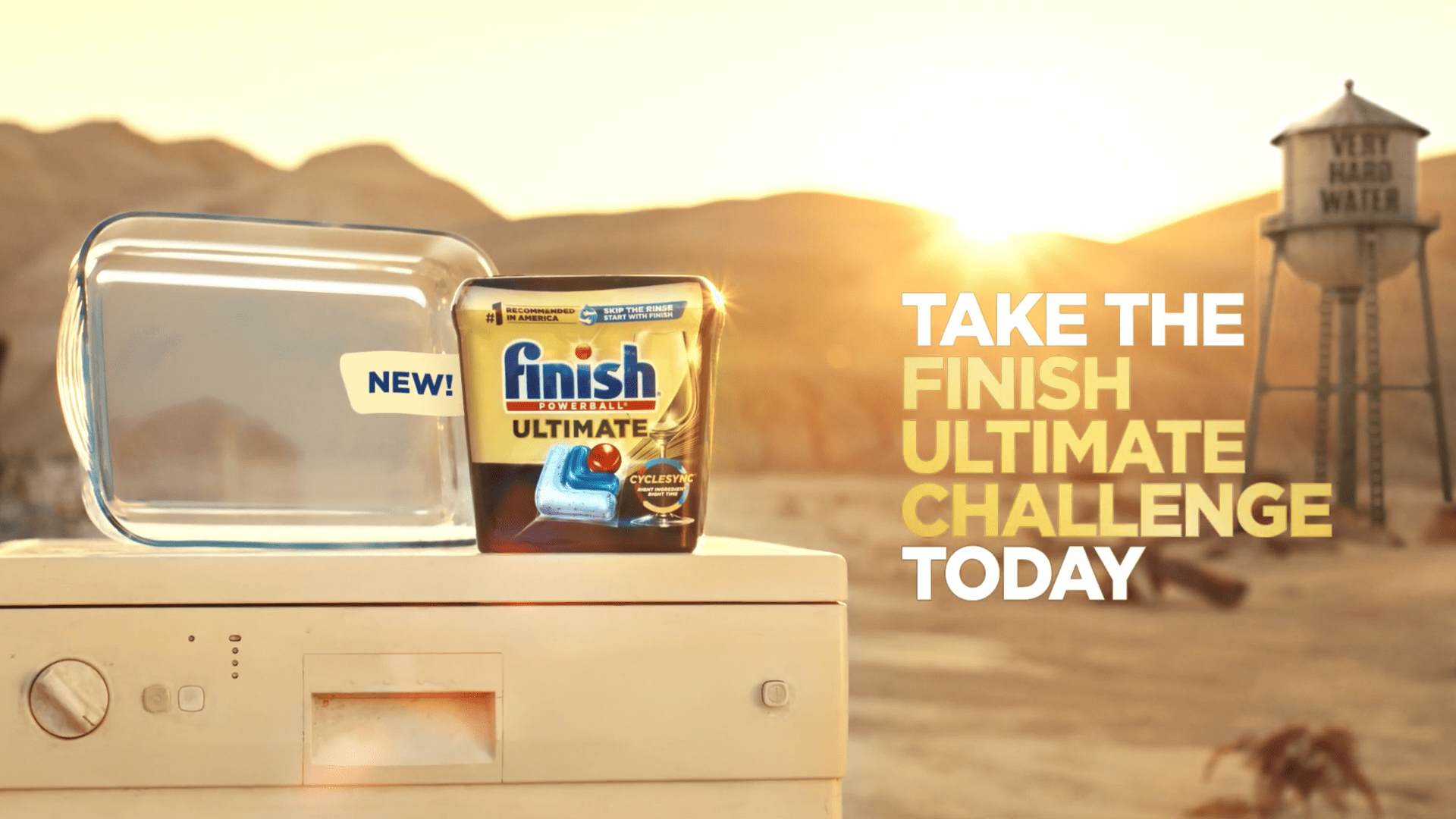 Dishwasher detergent pack displayed on a dishwasher with a desert landscape in the background