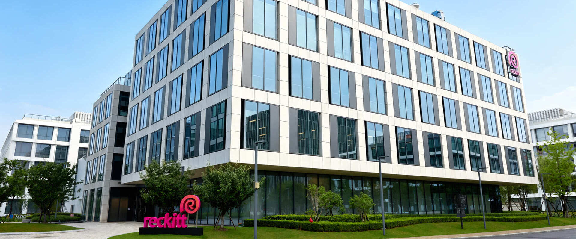 Modern office building with landscaped grounds viewed from the street