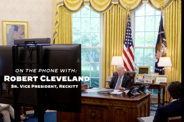 President Joe Biden in the Oval Office during a video call with on-screen Reckitt executive text