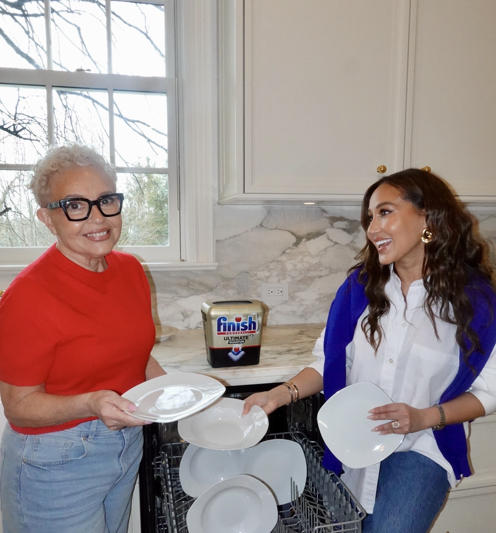 Two women smiling together in a kitchen with a Finish product on the countertop