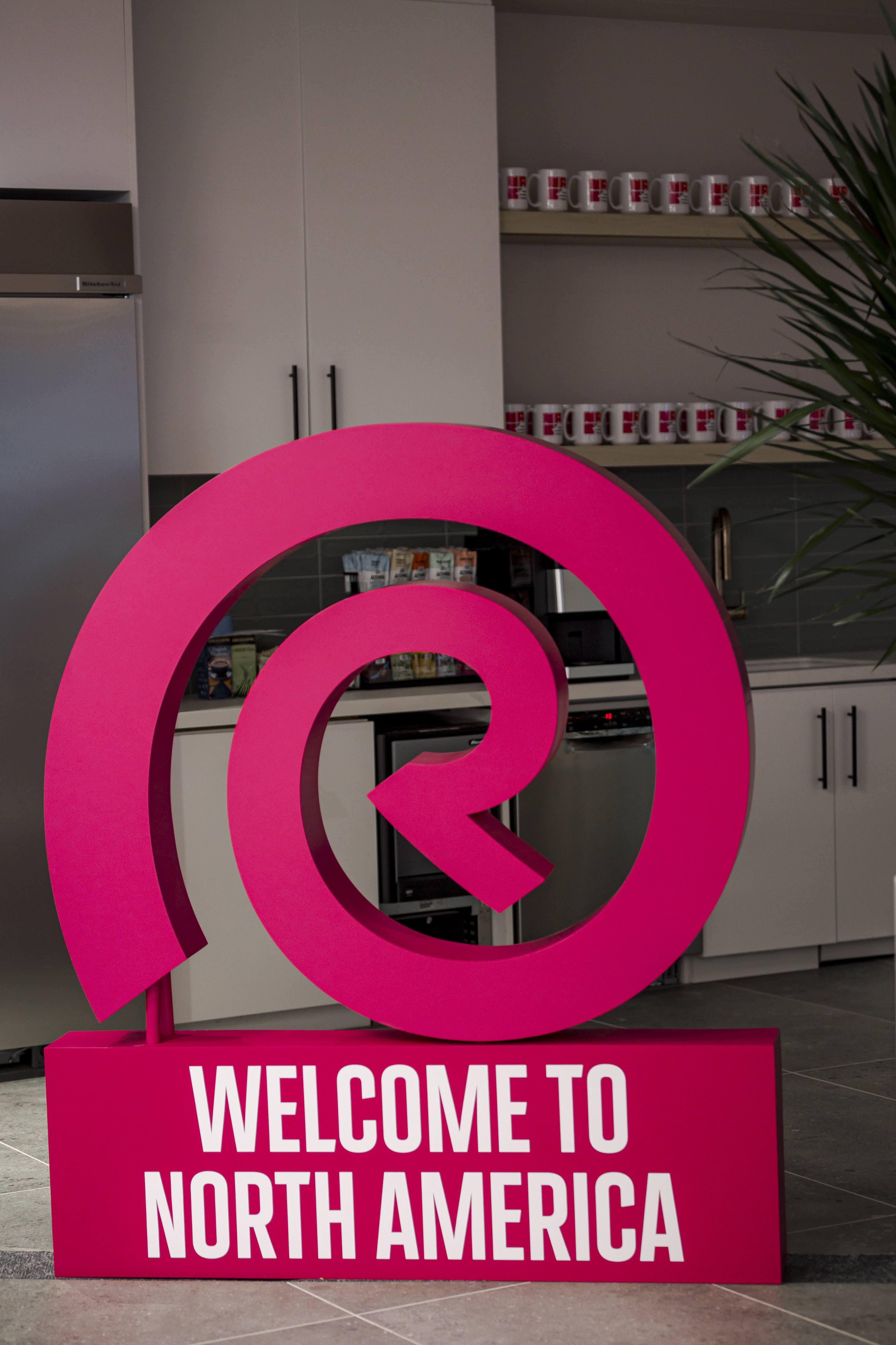 Reckitt welcome sign displayed in a North America office kitchen area