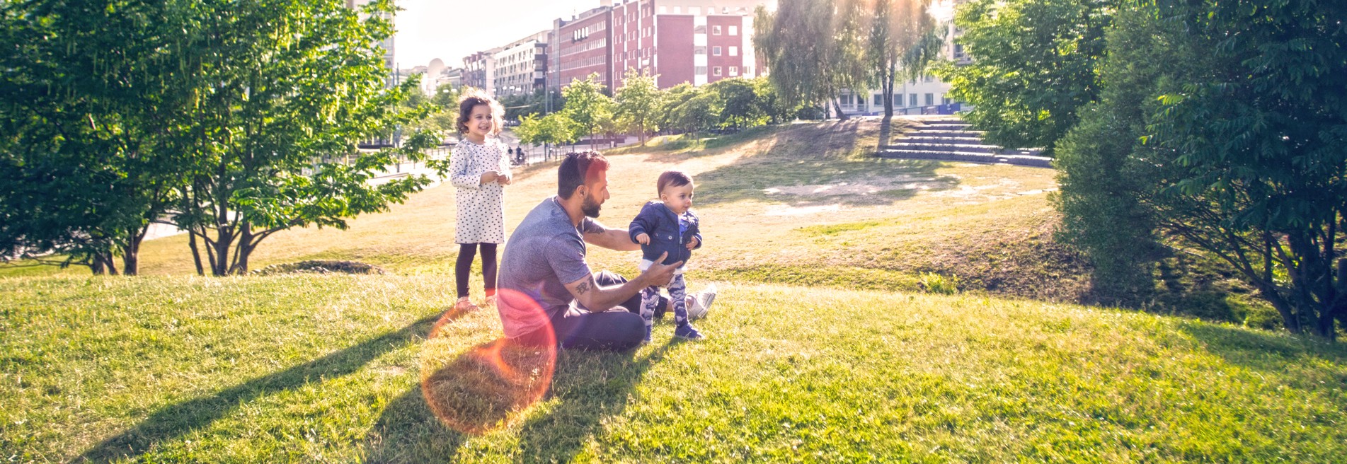 Parent and children enjoying time together in a sunny park