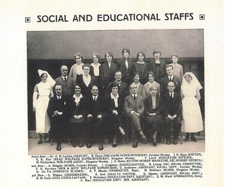 Group portrait of social and educational staff, including nurses and officials.