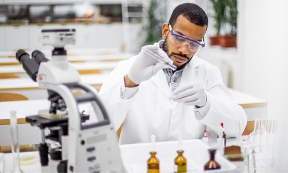 Scientist conducting laboratory research and handling a test tube in a lab setting