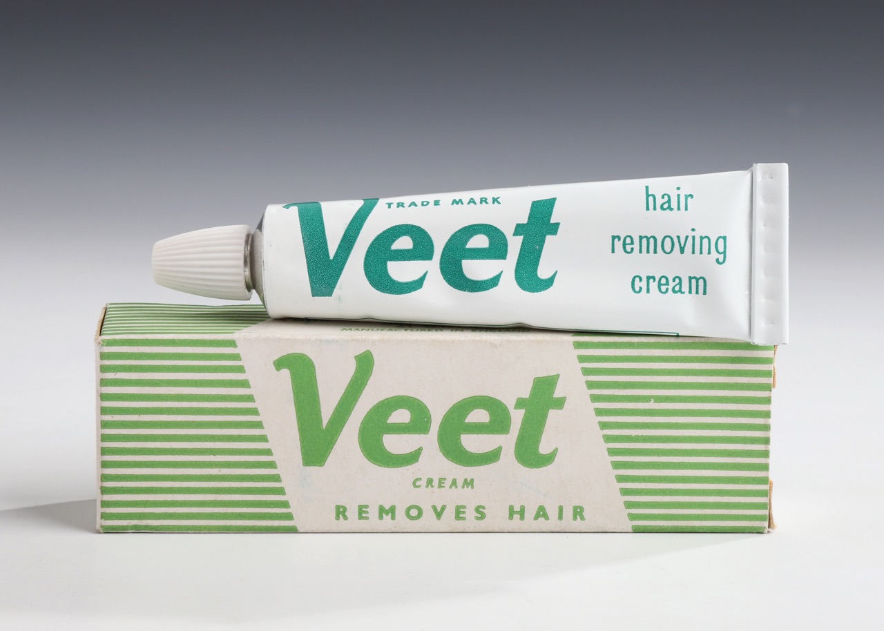 Veet hair removal cream tube placed on its packaging box.