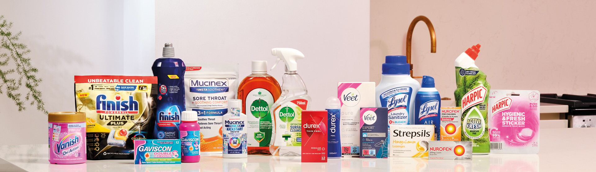 Collection of household, health, hygiene, and cleaning products displayed on a countertop in a home setting