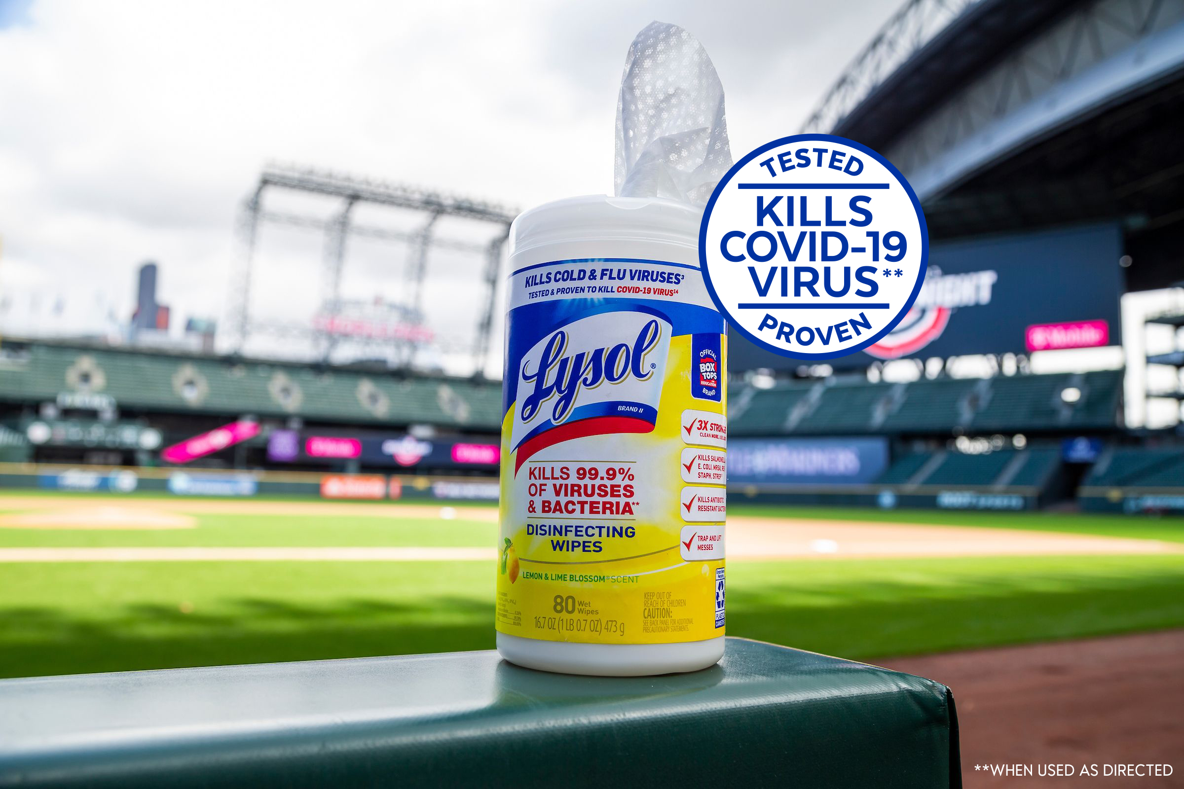 Lysol disinfecting wipes container displayed at a baseball stadium with a COVID-19 protection badge