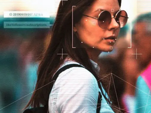 Woman walking down a busy street holding a smartphone