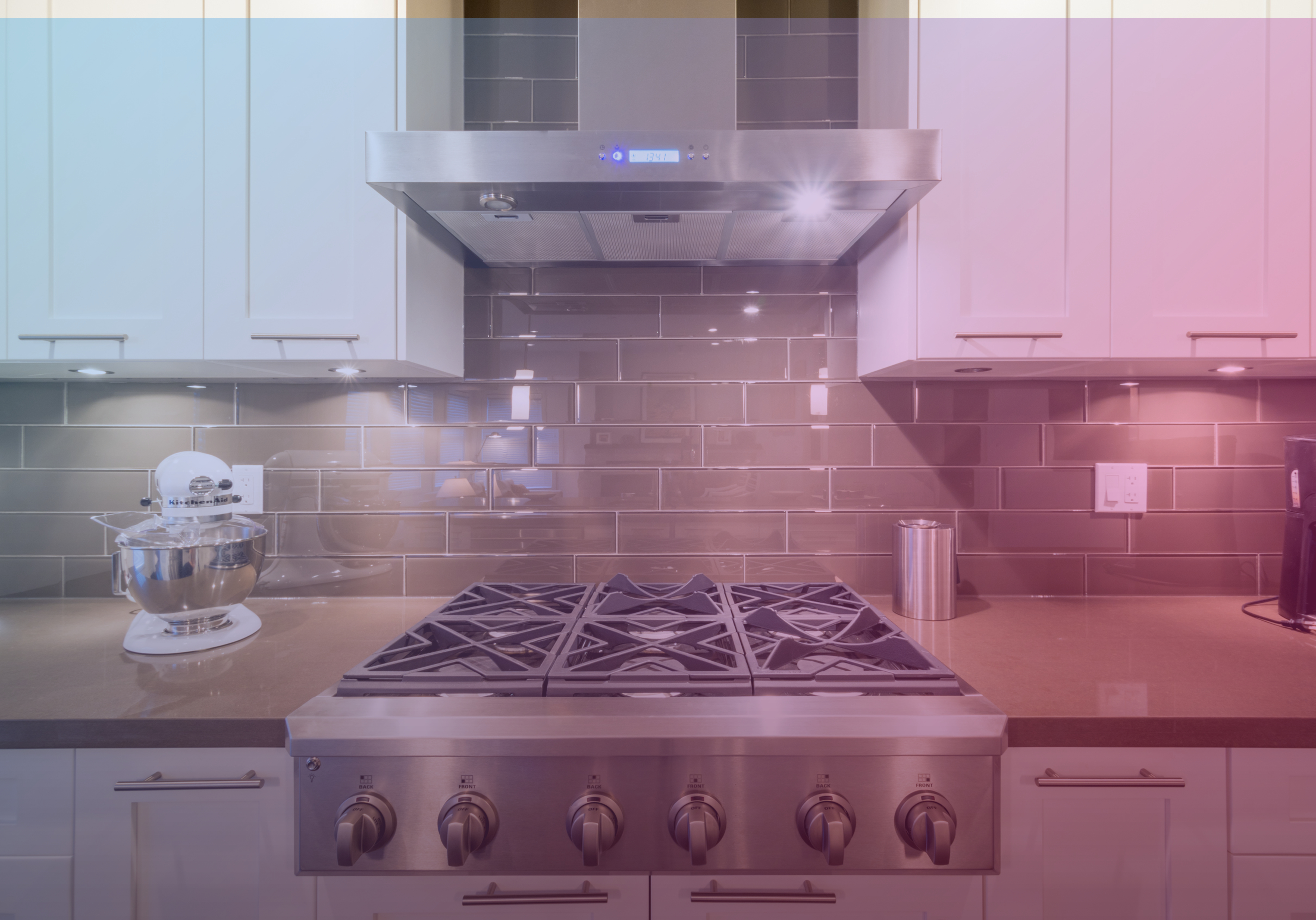 Modern kitchen with stovetop and countertops under soft lighting overlay