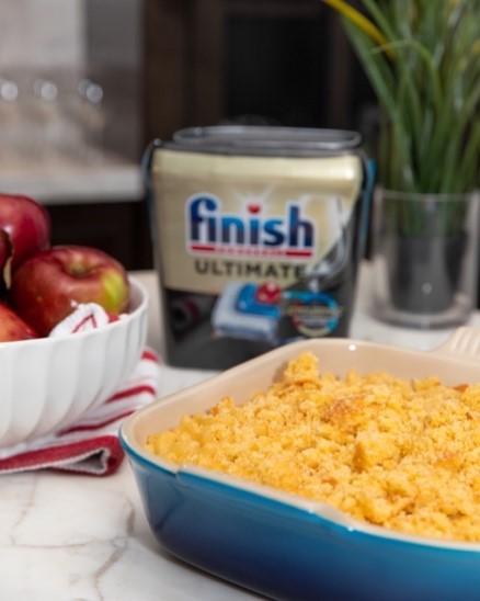Baked dish on a kitchen counter with Finish Ultimate dishwasher detergent products in the background