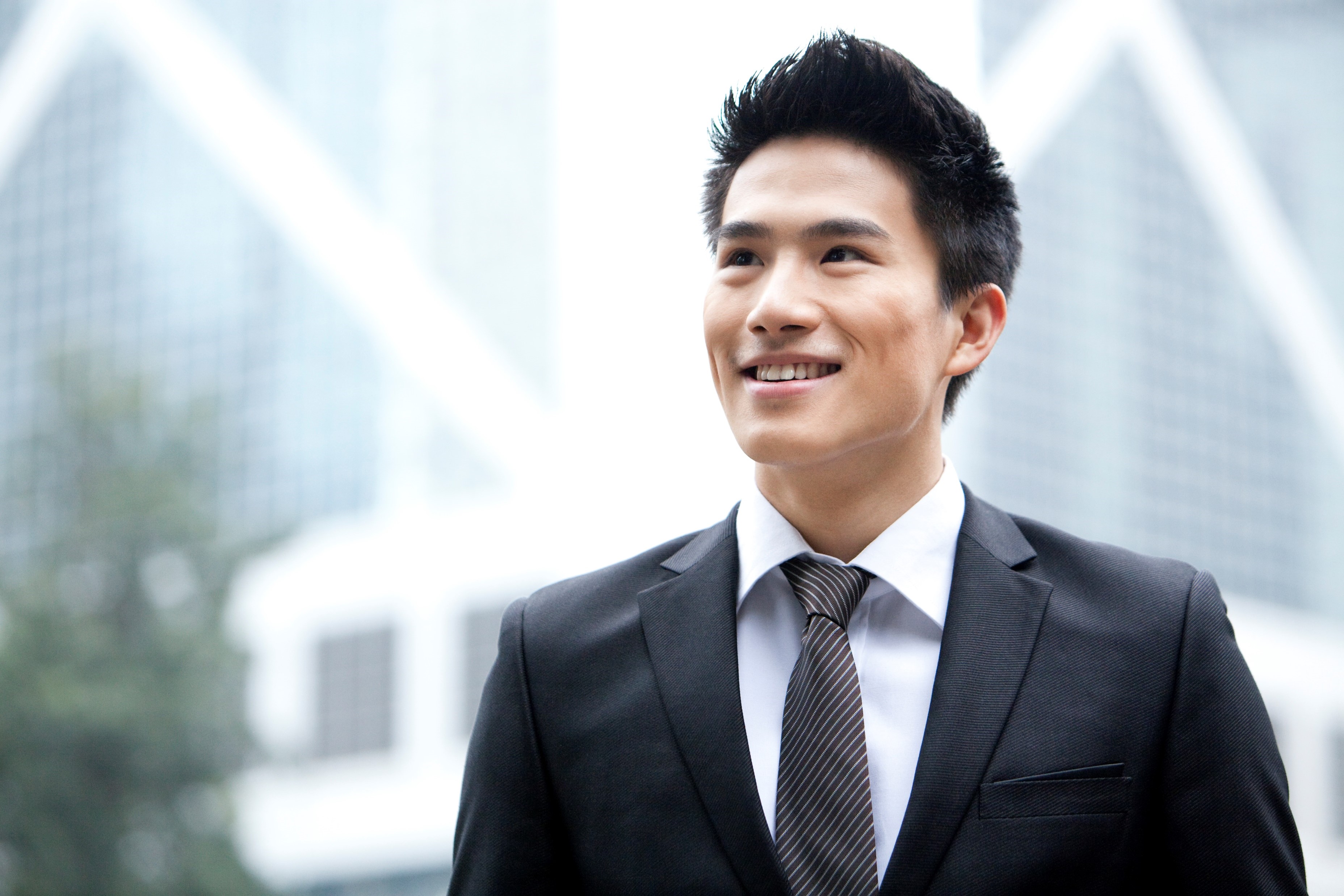 Business professional smiling outdoors in an urban office setting