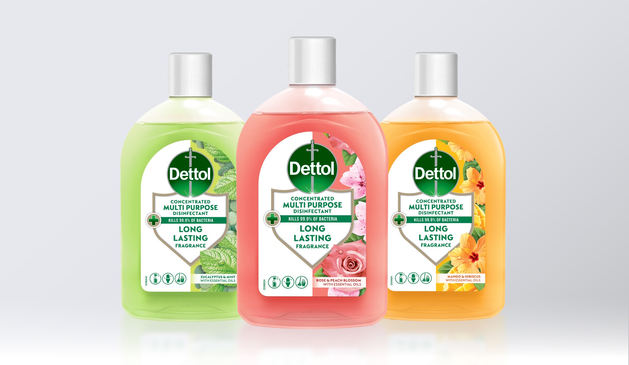 Three Dettol disinfectant bottles in green, pink, and orange.