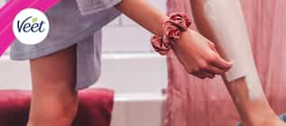 Veet banner featuring a woman applying hair removal cream to her leg
