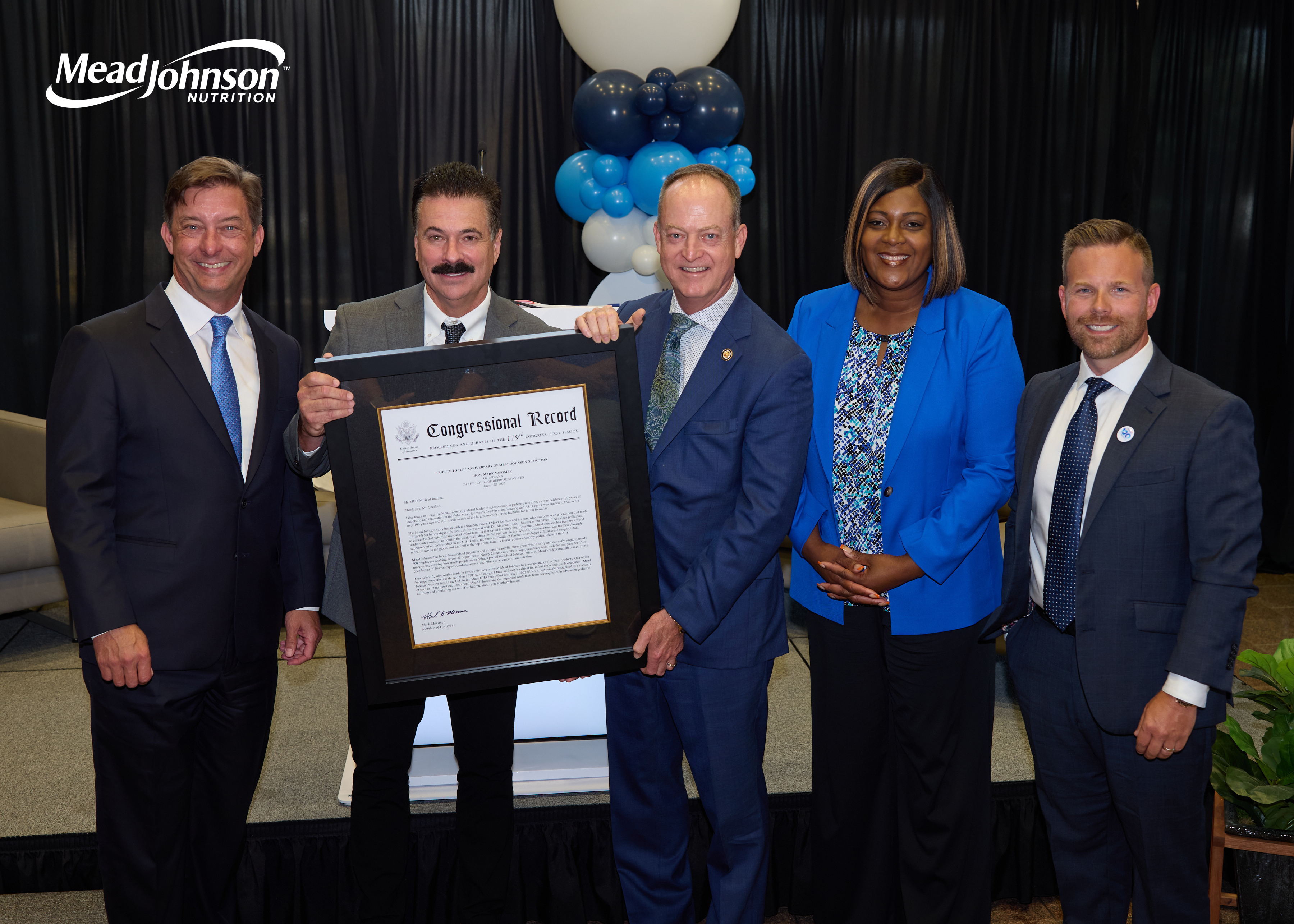 Five leaders posing with a framed recognition award at a Mead Johnson Nutrition event