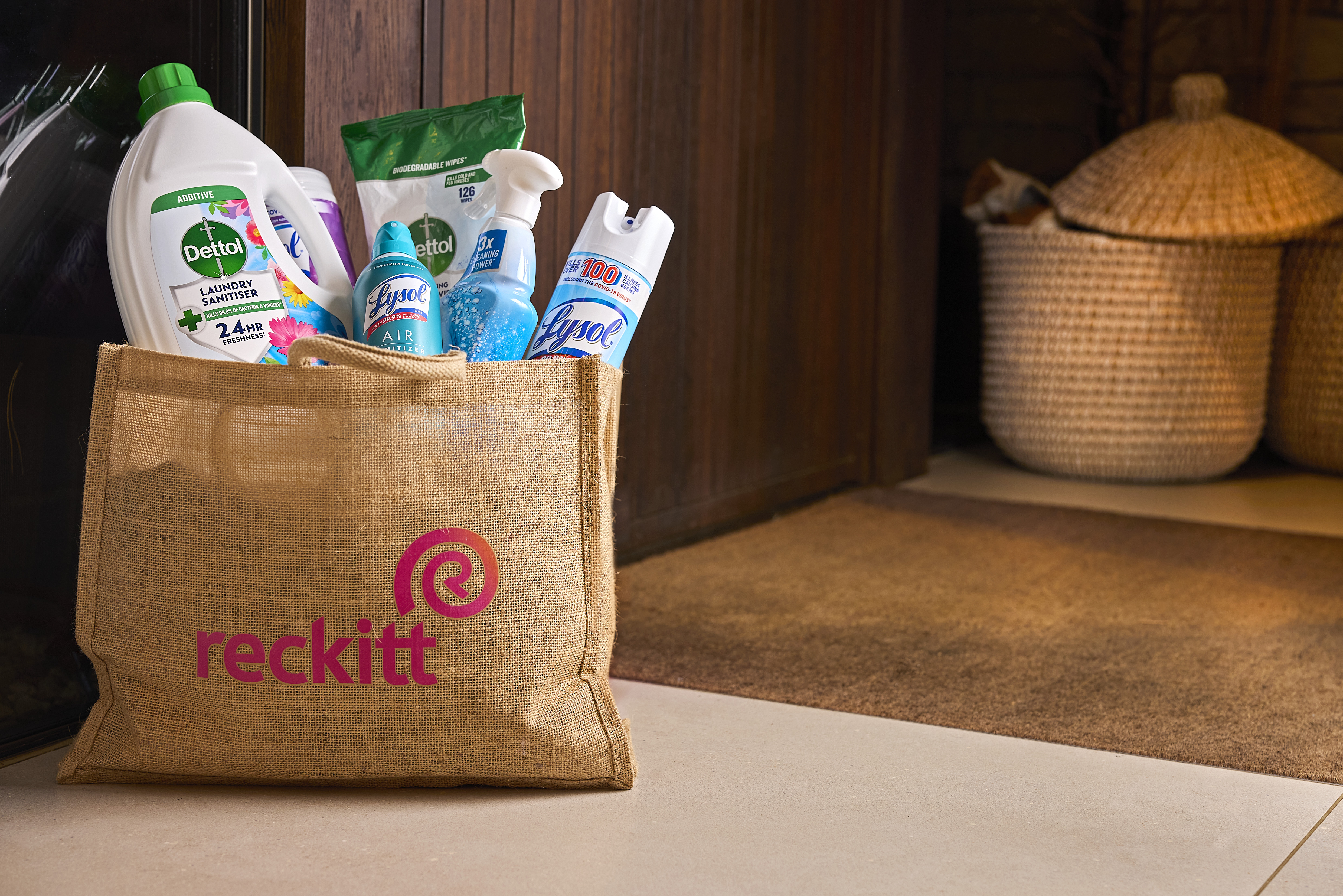 Assortment of household cleaning and healthcare products arranged on a kitchen counter.