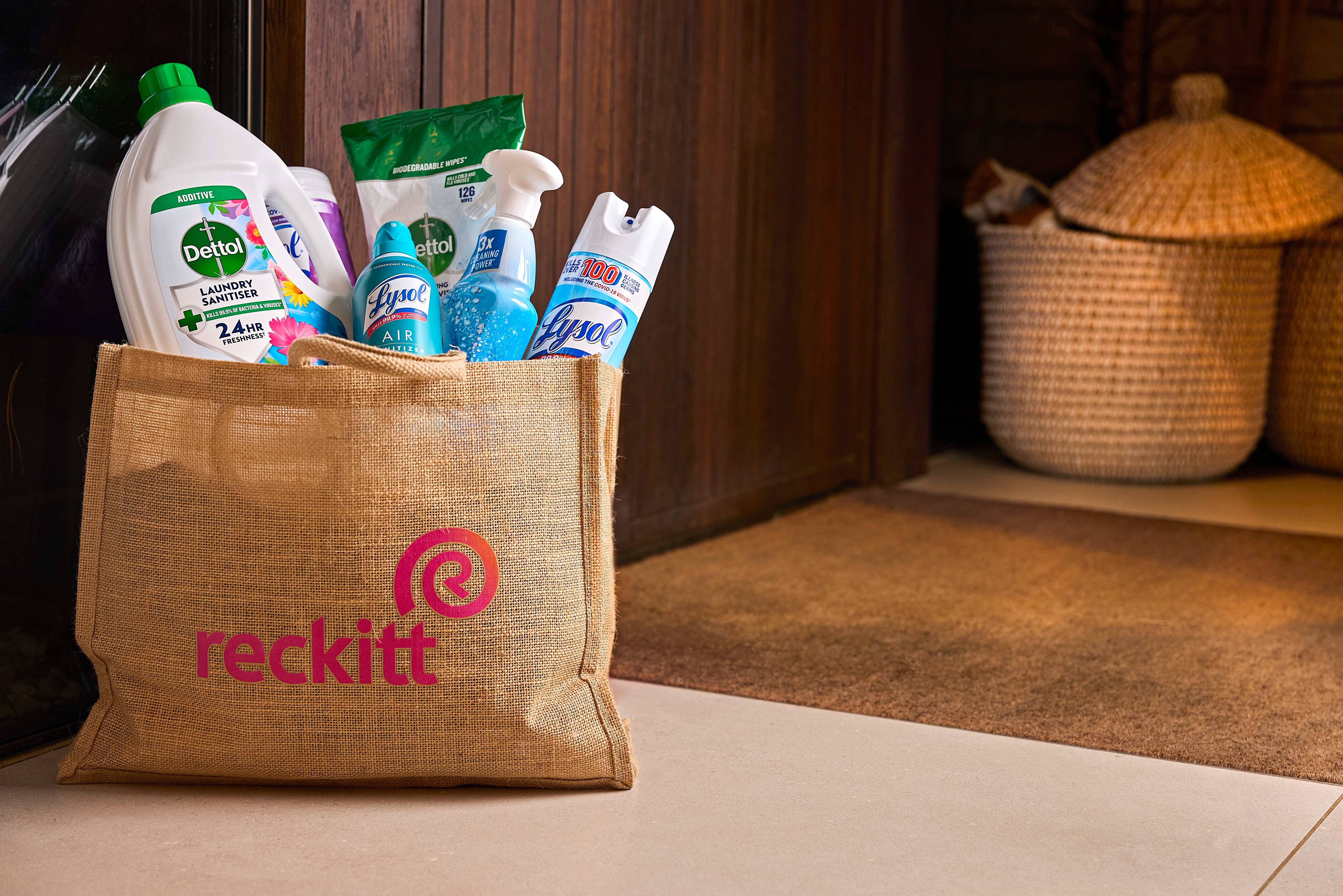 Assortment of household cleaning and healthcare products arranged on a kitchen counter.