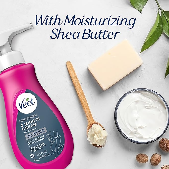 A pink bottle of Veet Professional 2 Minute Hair Removal Cream surrounded by shea butter, a wooden spoon, a soap bar, and green leaves.