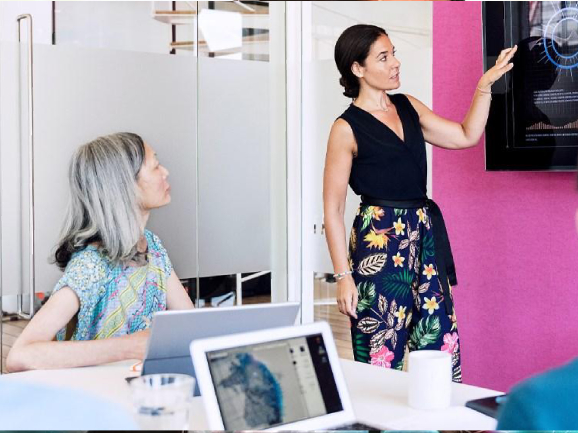 Businesswoman using graphs on the screen in a business meeting.