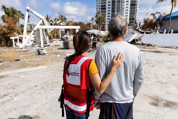American Red Cross volunteer supporting a resident in a hurricane-damaged community