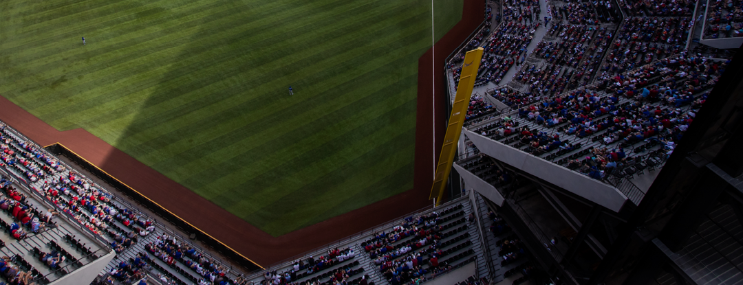View of a baseball stadium with fans seated around the field during a game