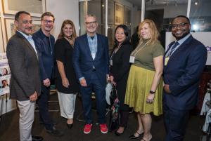 Group of professionals posing together at an indoor networking or business event