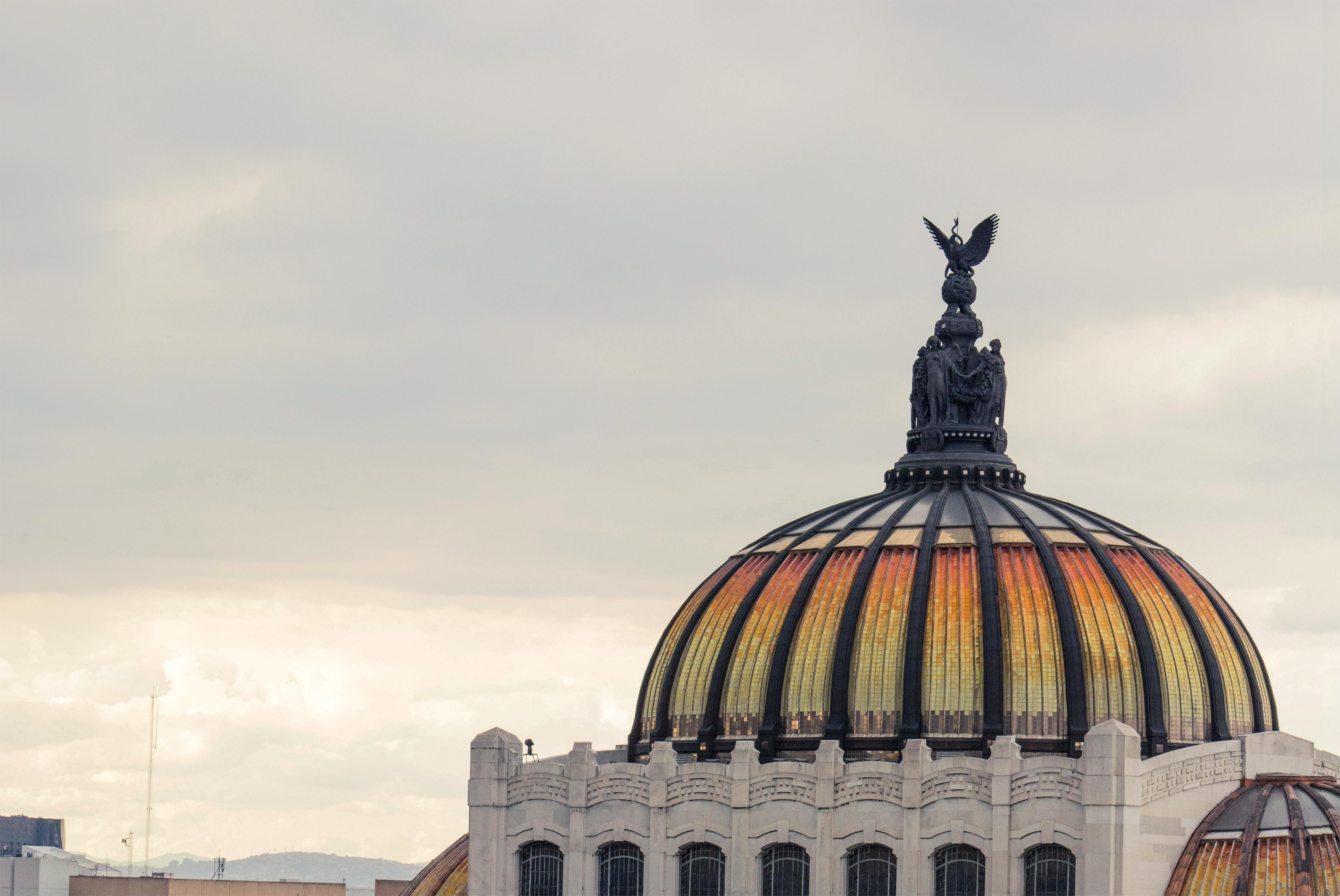 Dome of the Palacio de Bellas Artes in Mexico City under a cloudy sky
