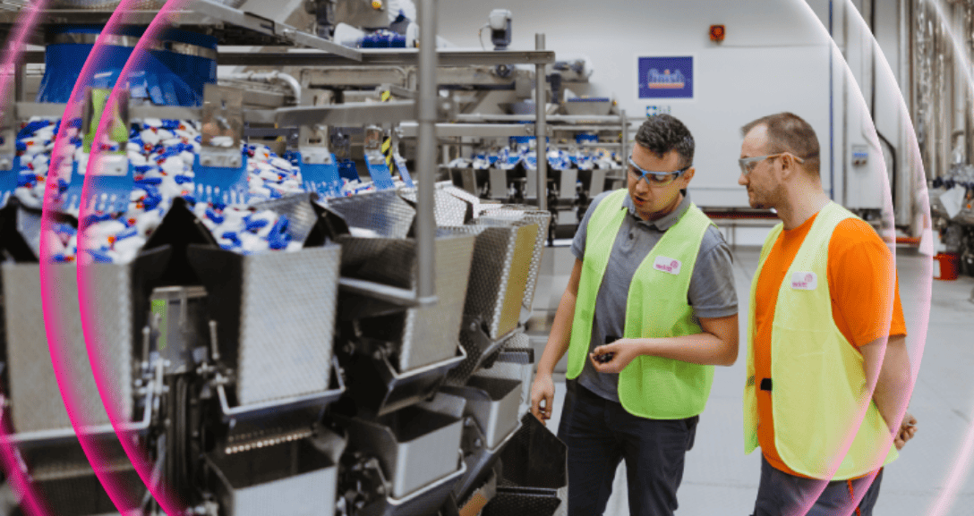 Employees inspecting a production line at a Reckitt manufacturing facility