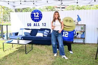 A Mucinex promotional setup featuring the 12-hour campaign, a product display, and the brand mascot