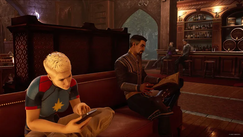 A screenshot of Marvel's Midnight Suns. Doctor Strange and Carol Danvers lounge in The Abbey.