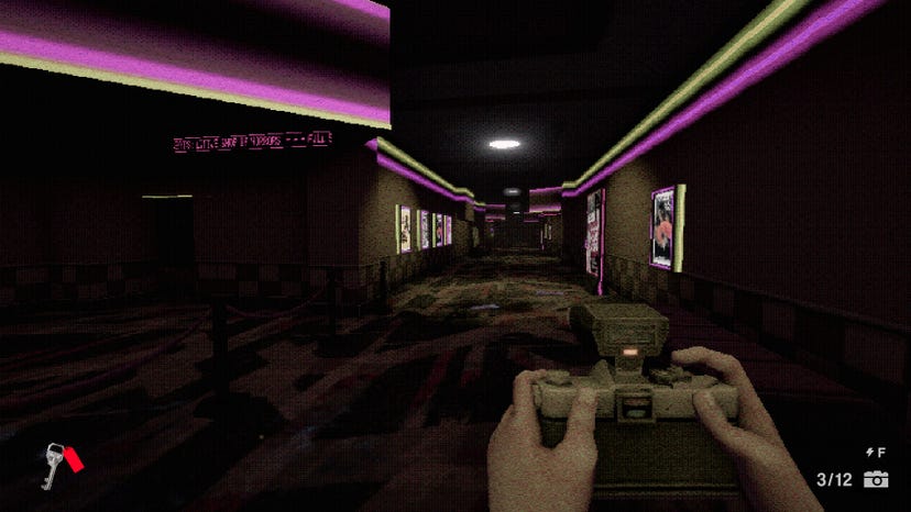 A screenshot from Interior Worlds show a dark room lit by neon strip lighting, as a set of hands hold a camera.