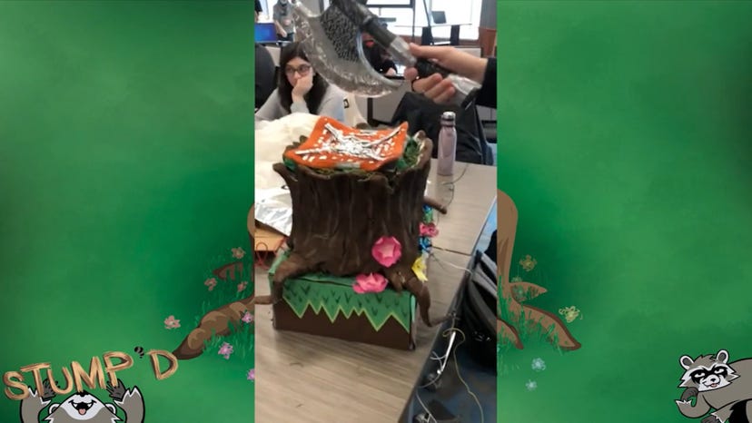 an axe held aloft over a stump controller