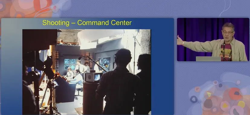 speaker warren davis showing a still from behind the scenes shooting at the game's command center