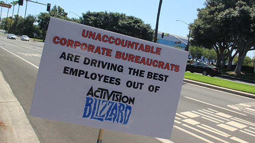 A sign stating "Unaccountable Corporate bureaucrats are driving the best employees out of Activision Blizzard."