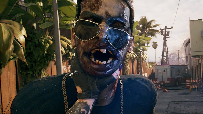 A screenshot from Dead Island 2 showing a survivor holding back a zombie