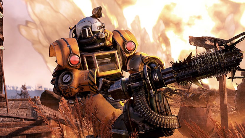 A screenshot of Fallout 76. A person wearing power armor wields a gatling gun.