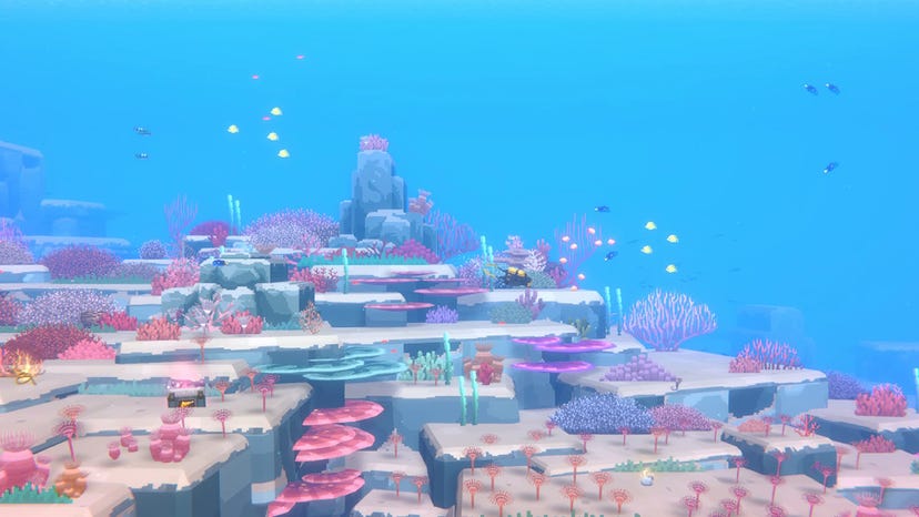 A screenshot from Dave the Diver shows Dave diving towards a colorful reef against a 2D, bright blue ocean background.