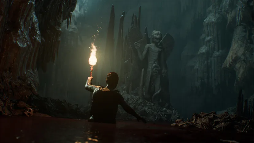 A screenshot from The Dark Pictures Anthology: House of Ashes showing a character holding a torch in a tomb