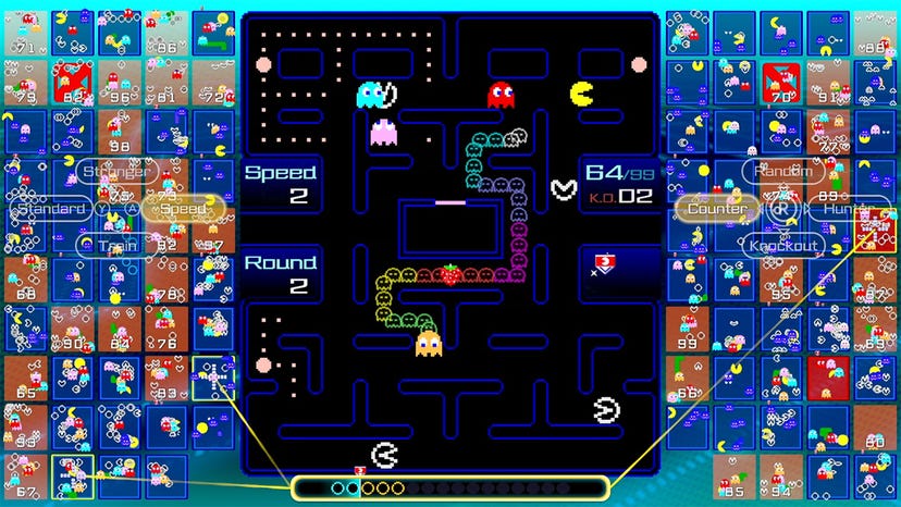A screenshot from Pac-Man 99 showing players being chased by ghosts