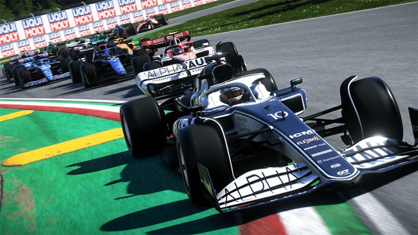 A screenshot from F1 2022. A blue car leads the way on a racetrack.