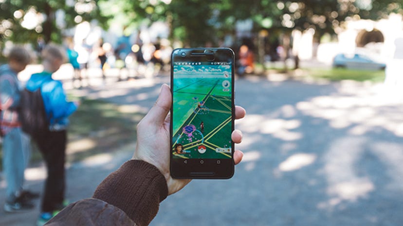 A man plays Pokemon Go on an iPhone