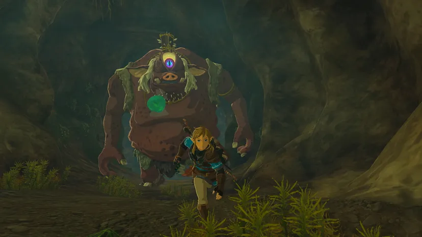 Link running away from an ogre in a cave