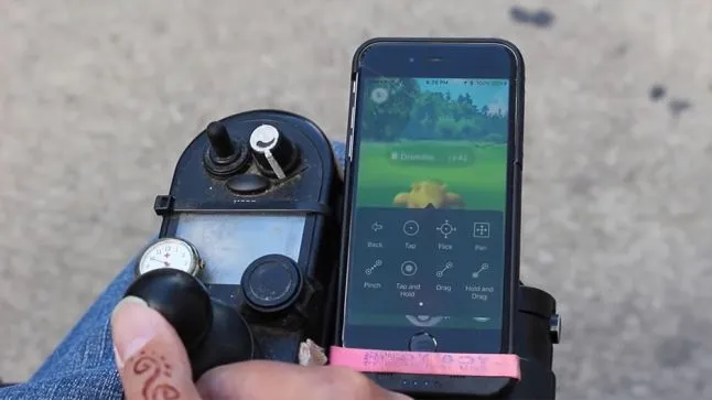 Pokemon Go being played with a single electric wheelchair button