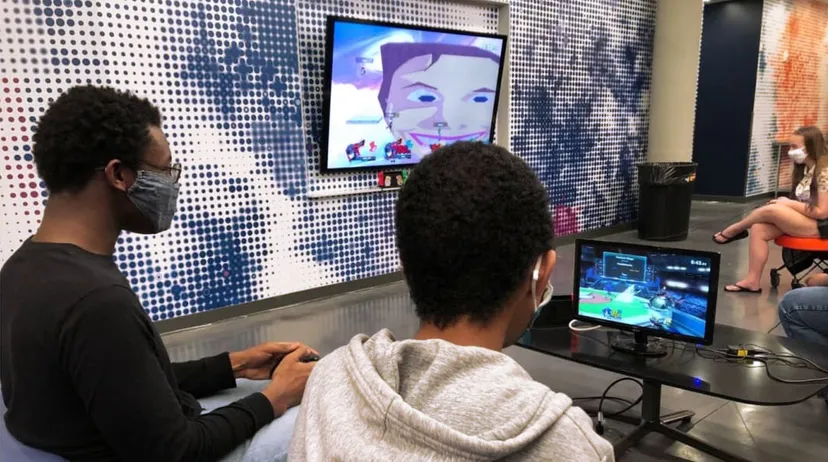 A photograph of two people playing Super Smash Bros.