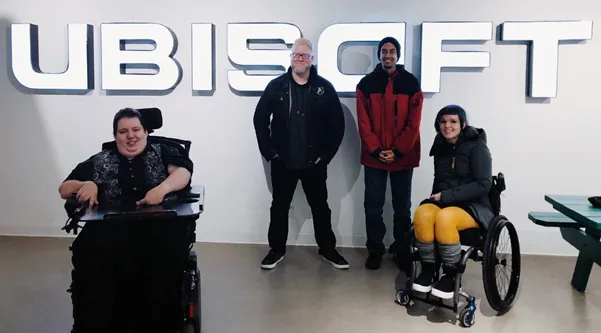 Disabled gamers in front of a large ubisoft logo