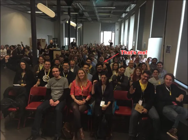 An image taken from the main stage of the Game UX Summit, showing a full room of UX professionals waving at the camera.