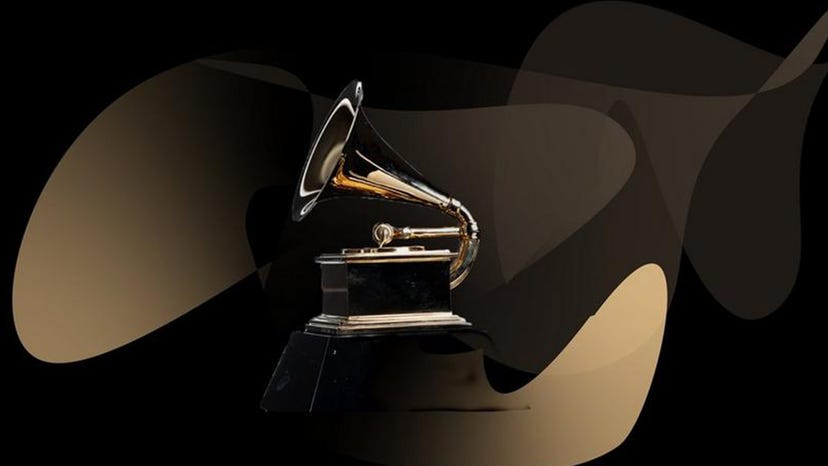 The Grammy award on a marbled gold background.