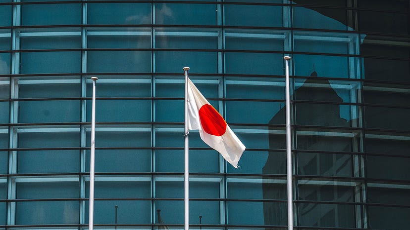 the Japanese flag in front of an office building