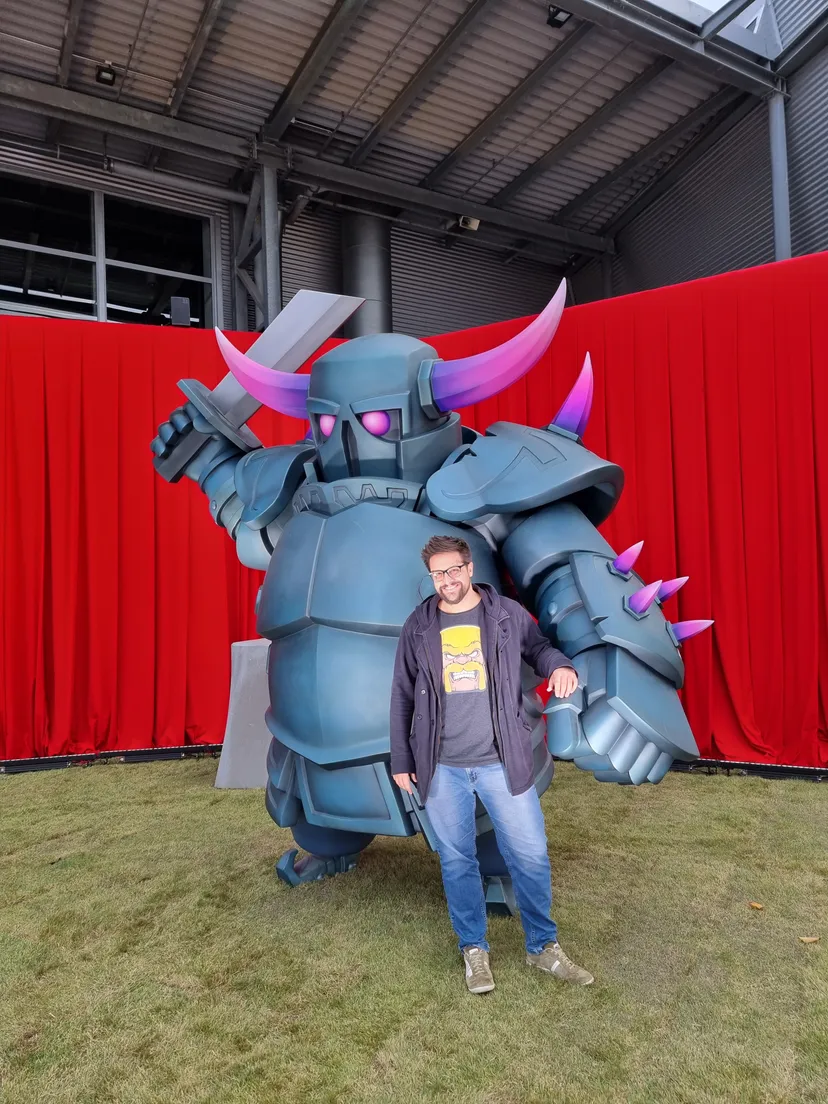 A photo of Alex Roque in front of a Clash of Clans armored monster.