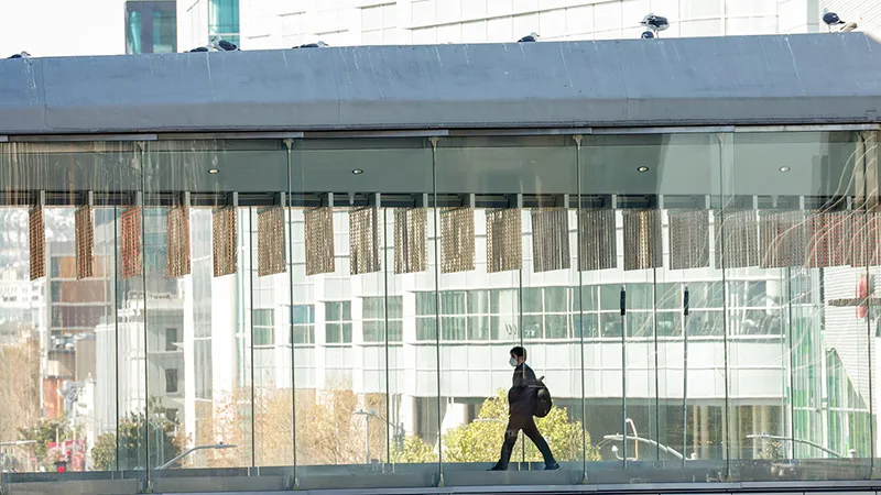 A GDC attendee walks across the SkyBridge.