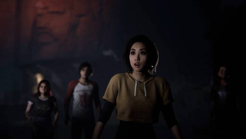 A Screenshot of The Quarry. The game's cast looks off camera in horror at an unknown object.